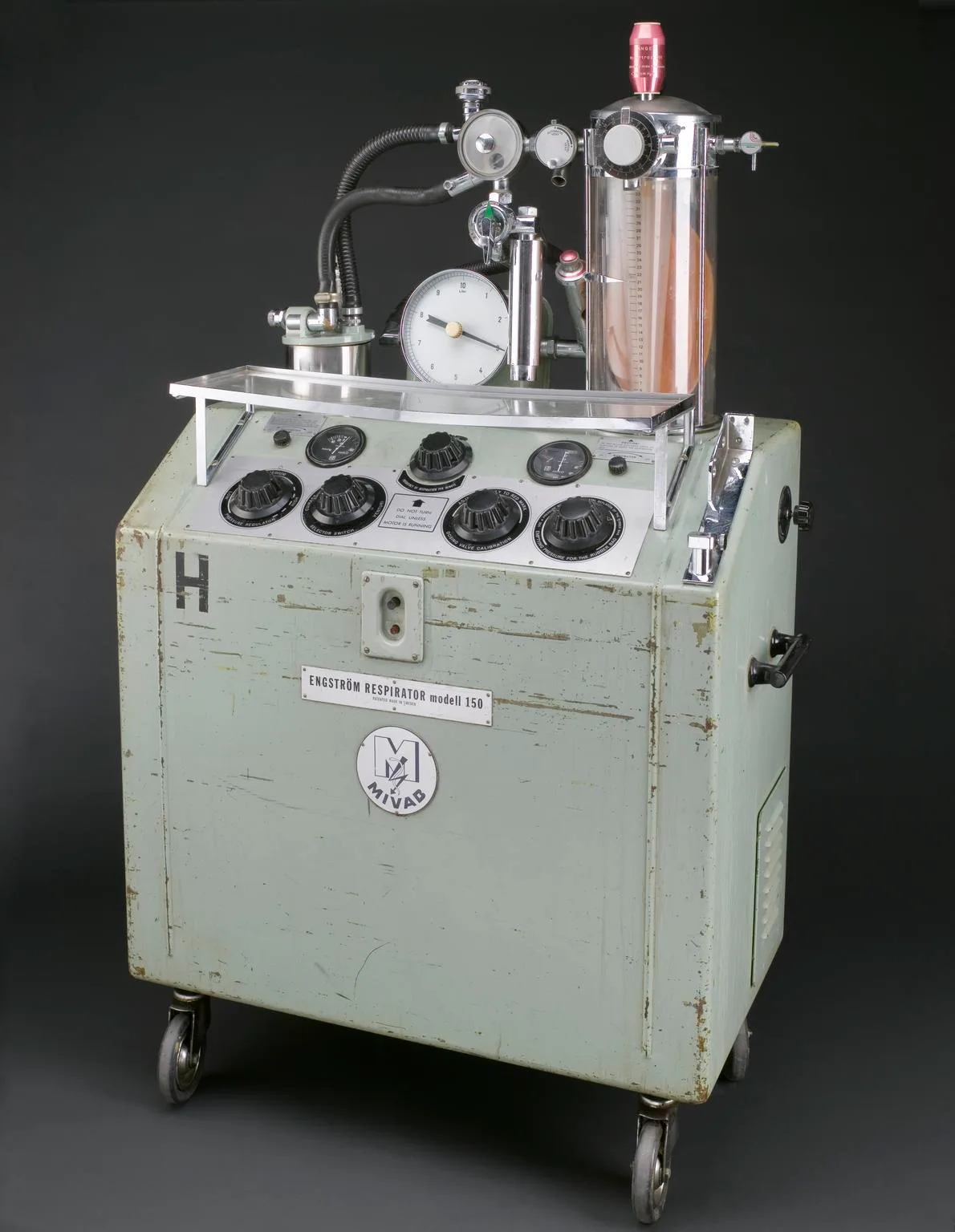 An Engstrom respirator, a wheeled mid-century mechanical ventilator cabinet.